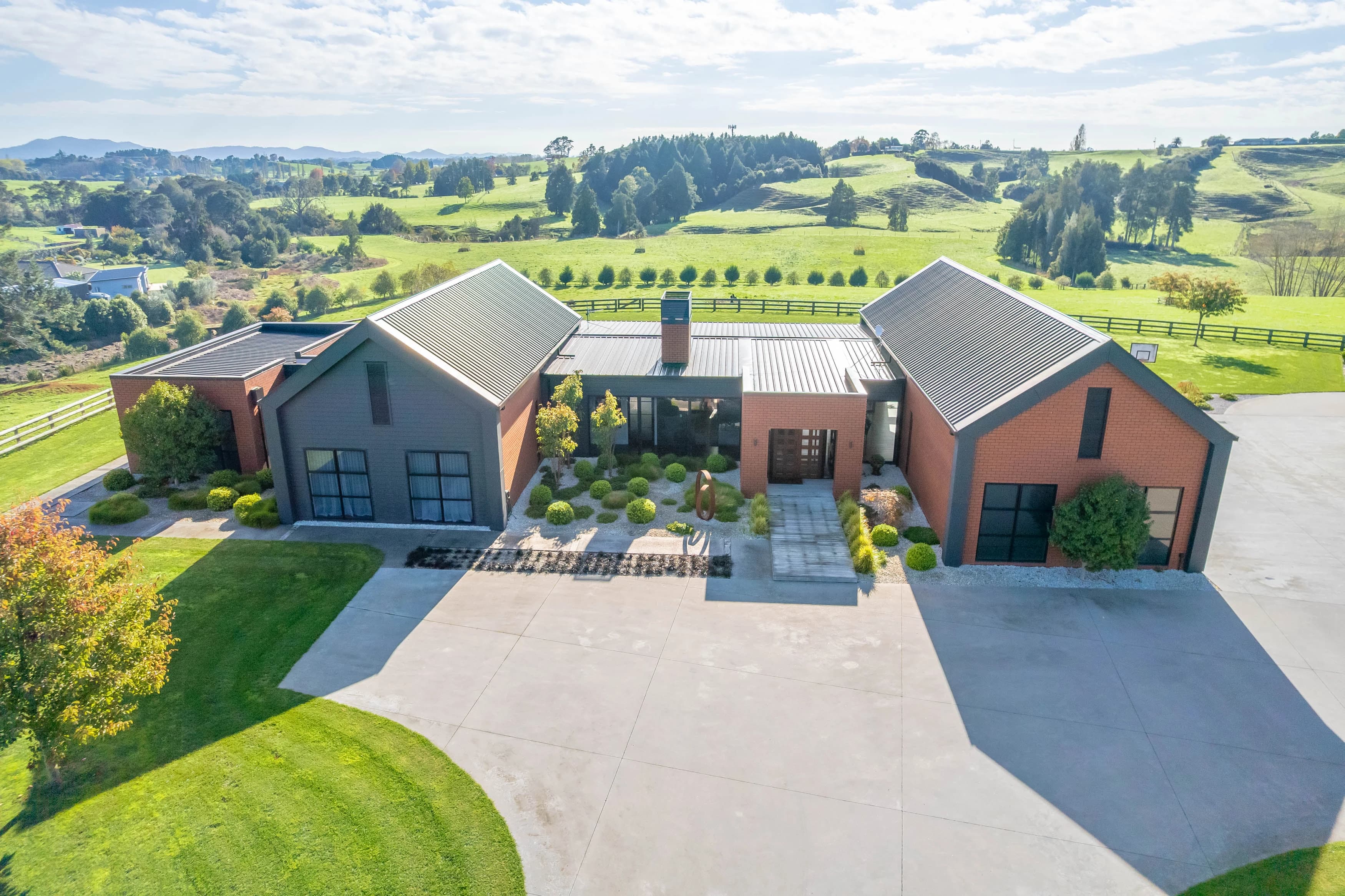 Backyard view of brick home with pool and alfresco area in Hamilton build
